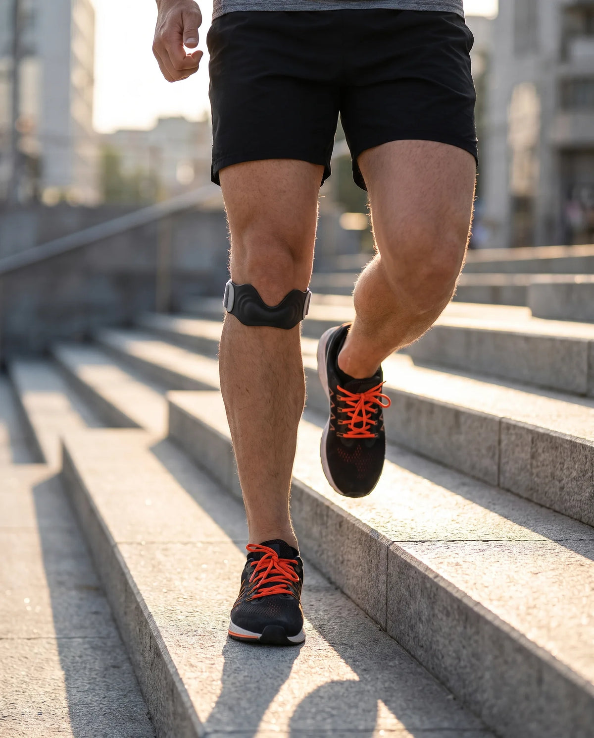 Runner on stairs wearing a patellar tendon strap for jumper's knee